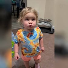A child making a playful, cheeky facial expression.