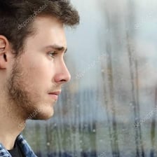 A person gazing into the distance with a longing expression