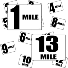 Runners in a half marathon near a distance marker.