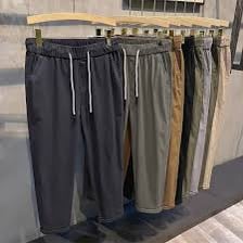 A pair of casual trousers hanging on a clothing rack.