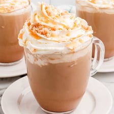 A cup of mocha topped with milk foam.