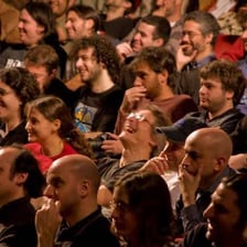 An audience laughing during a comedy performance