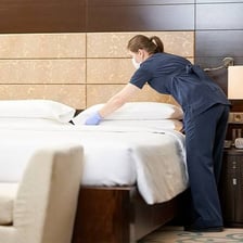 A hotel bed prepared with its covers folded back for turndown service