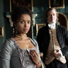 A formal period-drama scene in which a woman is addressed respectfully.