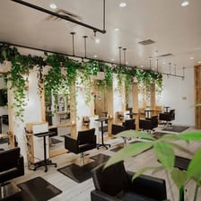 The interior of a hair and beauty salon with styling stations