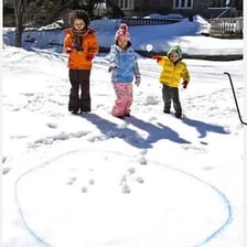 People throwing snowballs toward a target.