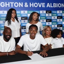 An athlete signing a contract to become a professional.
