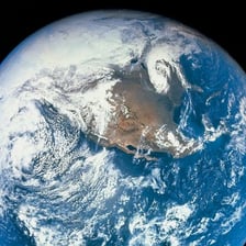 A thin blue layer of atmosphere surrounding Earth.