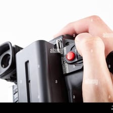 A person starting a video recording by pressing a camera button