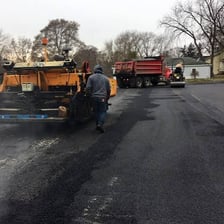 A paved parking lot with a dark asphalt surface.