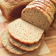 A loaf of seeded rye bread, shown sliced