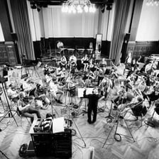 An orchestra recording music for a film.