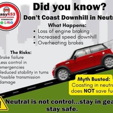 A car traveling downhill on a road.