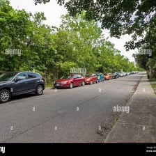 Several automobiles parked along a street.