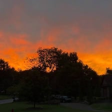 The sun rising above a distant horizon.