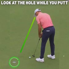 A golfer making a putt near the hole.