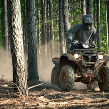 An all-terrain vehicle traveling on a dirt trail