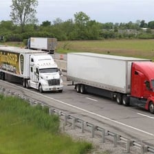 A tractor-trailer truck traveling on a highway.