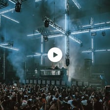 A DJ performing electronic dance music at a festival