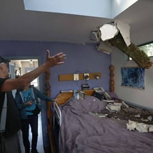 A room with extensive damage and scattered debris.
