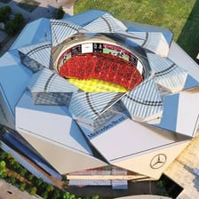 A large indoor stadium covered by a domed roof.