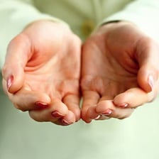 A hand gently caressing another person’s arm.