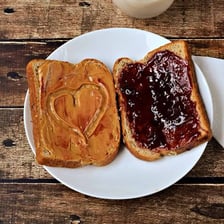A sliced peanut butter and jelly sandwich on a plate