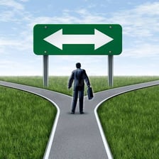 A person choosing a straight path at a fork in the road