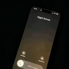 A person waiting outside and asking someone to pick them up.