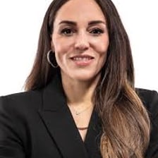Adia Barnes coaching on a college basketball sideline