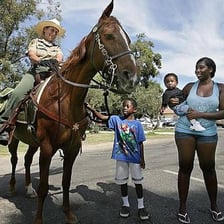 A group of riders representing a traditional Western posse.