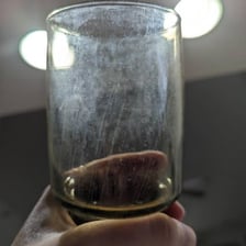 A visibly dirty drinking glass before cleaning