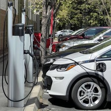 Electric vehicles connected to charging stations.