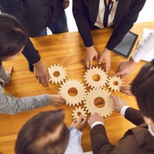 A group of people putting their hands together as a team
