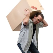 A person lifting a box, showing the ability to perform a task.
