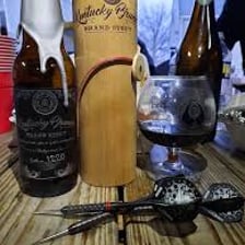 A liquor bottle lying on its side on a table.