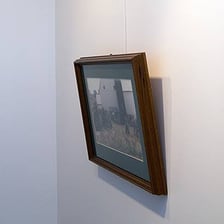 A picture frame hanging at a noticeable angle