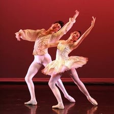 Two ballet dancers performing a pas de deux.