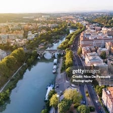 A view of Rome with the Tiber River in the foreground.