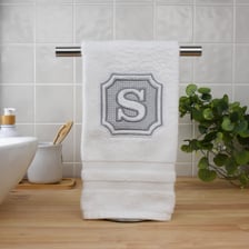 A monogram made from a person’s initials embroidered on fabric.