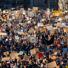 A Black Lives Matter protest with signs held by participants.