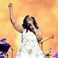 Aretha Franklin performing onstage.