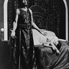 An actor portraying Iago in a stage production of Shakespeare’s Othello.