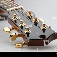 A close-up of the tuning pegs on a guitar headstock