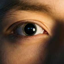 A close-up view of an eye with a widened pupil