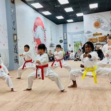 Karate students practicing in a dojo.