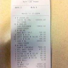 A bar receipt listing drinks and the amount owed.