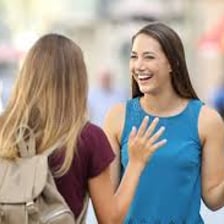 Two friends greeting each other casually