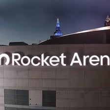 A large sports arena with corporate naming signage.