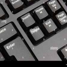 A computer keyboard with the Delete key visible